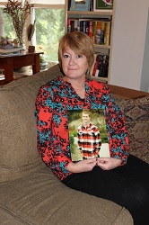 1) Justin Phillips holds a photo of her son